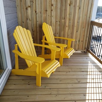The Quarterdeck Beachside Villas and Grill - two yellow adiron chairs - Hotels Near Me