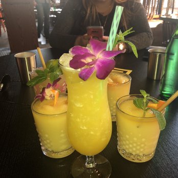 Navy Strength - Drinks (the one with the purple flower is the Hinky Dinks Fizzy, I recommend it) - Tiki Bars Near Me - Seattle, Washington