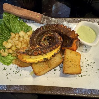 Aji Limo Peruvian Cuisine - Grilled Octopus with golden potatoes, white corn, and huacatay sauce. - Desserts Near Me - Tampa, Florida Aji Limo Peruvian Cuisine - Grilled Octopus with golden potatoes, white corn, and huacatay sauce. - Desserts Near Me - Tampa, Florida