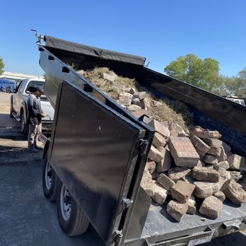 RC Custom Landscape & Stone Work - a man loading a pile of rocks - Landscaping Near Me - Plano, Texas RC Custom Landscape & Stone Work - a man loading a pile of rocks - Landscaping Near Me - Plano, Texas