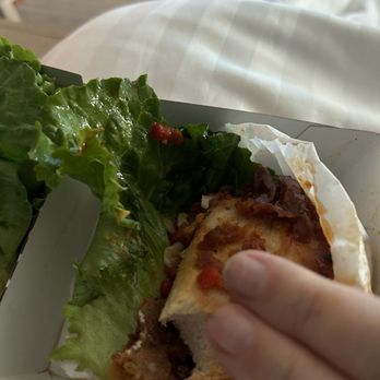 Shake Shack Century City Mall - 2nd Floor - Korean chicken, using my finger to scale how small this was with just 1 bite out of it - Fast Food Near Me - Los Angeles, California