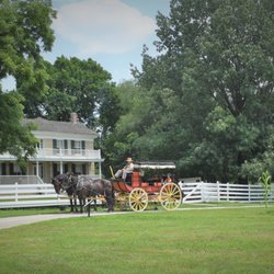 Mahaffie Stagecoach Stop & Farm - The mudwagon style stagecoach rests in front of the 1865 limestone Mahaffie home.