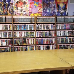 Showcase Comics - Graphic novels with long gaming table.