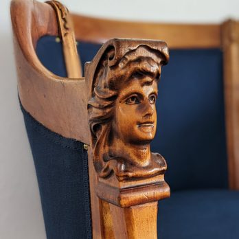 Classic House - Close up detail of 1800s hand carved captains chair reupholstered by Classic House - Furniture Reupholstery Near Me - Phoenix, Arizona
