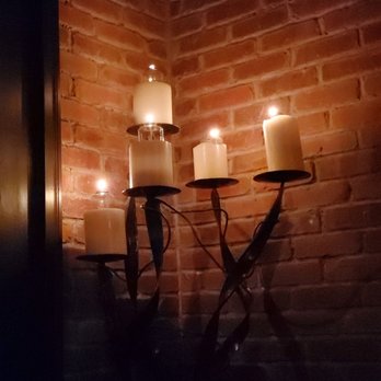 SO Restaurant-Bar - two candles on a brick wall - New American Near Me - Little Rock, Arkansas