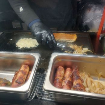 Ochidoggy - a person preparing hotdogs on a grill - Food Stands Near Me - San Diego, California Ochidoggy - a person preparing hotdogs on a grill - Food Stands Near Me - San Diego, California