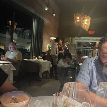 Zucca - The waiter, blonde hostess and host talking, laughing and ignoring tables - Italian Near Me - Coral Gables, Florida Zucca - The waiter, blonde hostess and host talking, laughing and ignoring tables - Italian Near Me - Coral Gables, Florida