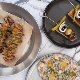 Octopus and pork belly skewers, Gildas (happy hour menu item), steak tartare Octopus and pork belly skewers, Gildas (happy hour menu item), steak tartare