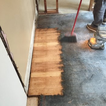Hardwood Floor Specialist - The original floors finally revealed after the first bit of black tar-like adhesive was removed. - Flooring Near Me - Vancouver, Washington Hardwood Floor Specialist - The original floors finally revealed after the first bit of black tar-like adhesive was removed. - Flooring Near Me - Vancouver, Washington