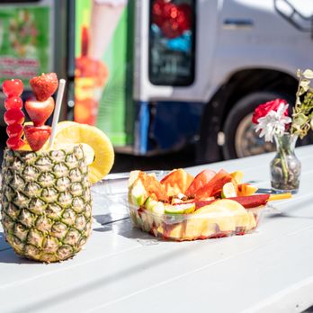 La Chula - a pineapple and fruit on a picnic table - Food Trucks Near Me - Raleigh, North Carolina