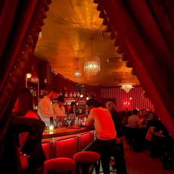 The Nines - a group of people sitting at a bar - New American Near Me - New York, New York