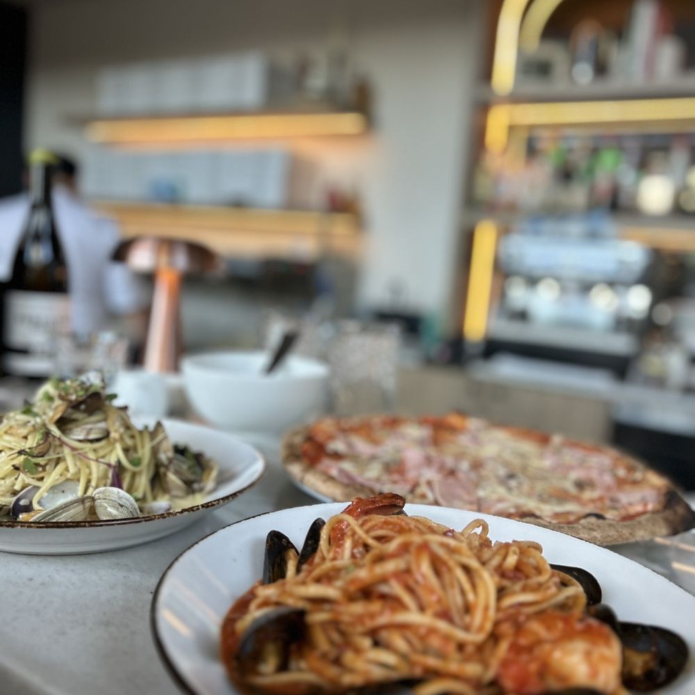 Claudio's - a variety of dishes of food on a counter - Italian Near Me - Burnaby, British Columbia