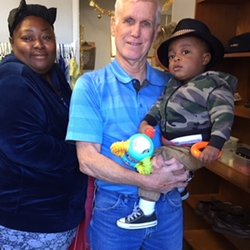 Birthline of San Diego County - A volunteer and a client with her child pose for a picture during the Christmas event.