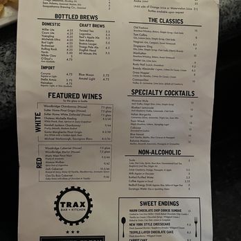 Trax - Beverage menu - The menu from Trax Bar & Kitchen displays sections for ice cold drafts, bottled brews, wines, specialty cocktails, non-alcoholic drinks, and desserts. It includes details such as prices, drink descriptions, and serving sizes. The menu emphasizes a selection of craft and domestic beers, wines by the glass or bottle, and a variety of cocktails and sweet endings like cheesecakes and rice pudding. - New American Near Me - Scranton, Pennsylvania