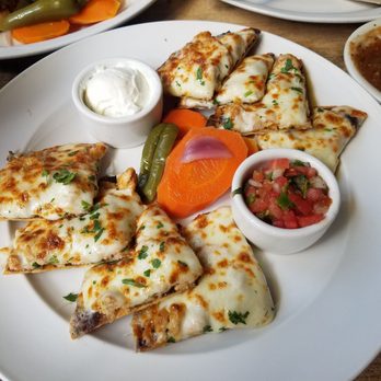 Cha Cha's Latin Kitchen - Cha cha's nachos with chicken and a flan. - Bars Near Me - Brea, California
