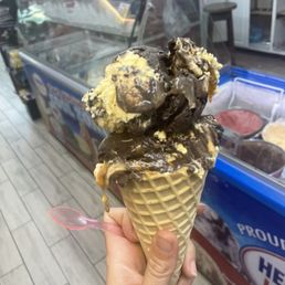 a hand holding an ice cream cone