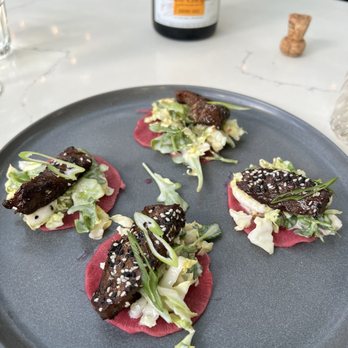 Benchmark - KOREAN BBQ TACOS, daikon radish, napa cabbage, jicama, thai chili, cilantro, arugula, apple, rice vinegar + yuzu vinaigrette - New American Near Me - Santa Ana, California