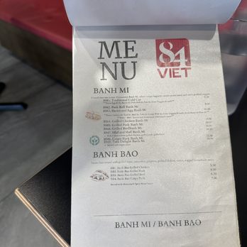84 Viet - Menu 4/10/2025 - The menu from a Vietnamese restaurant displays sections for Pho, Banh Mi, and Banh Bao. It includes items such as traditional cold cuts, pork roll, grilled chicken, pork, and beef options, with prices ranging from $5.50 to $10.00. The menu features descriptions of each dish, including ingredients like grilled meat, vegetables, and homemade sauces. The layout is simple, with text and small icons, and the menu is printed on white paper with black text and some red and blue accents. - Vietnamese Near Me - Berkeley, California