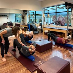 Moving Spirit - Pilates Teacher Sarah Moore cueing a client's form during a Core Essentials Pilates mat class.