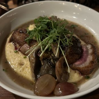 The Appalachian - Duck entree with grapes, and grits. - Steakhouses Near Me - Sevierville, Tennessee The Appalachian - Duck entree with grapes, and grits. - Steakhouses Near Me - Sevierville, Tennessee