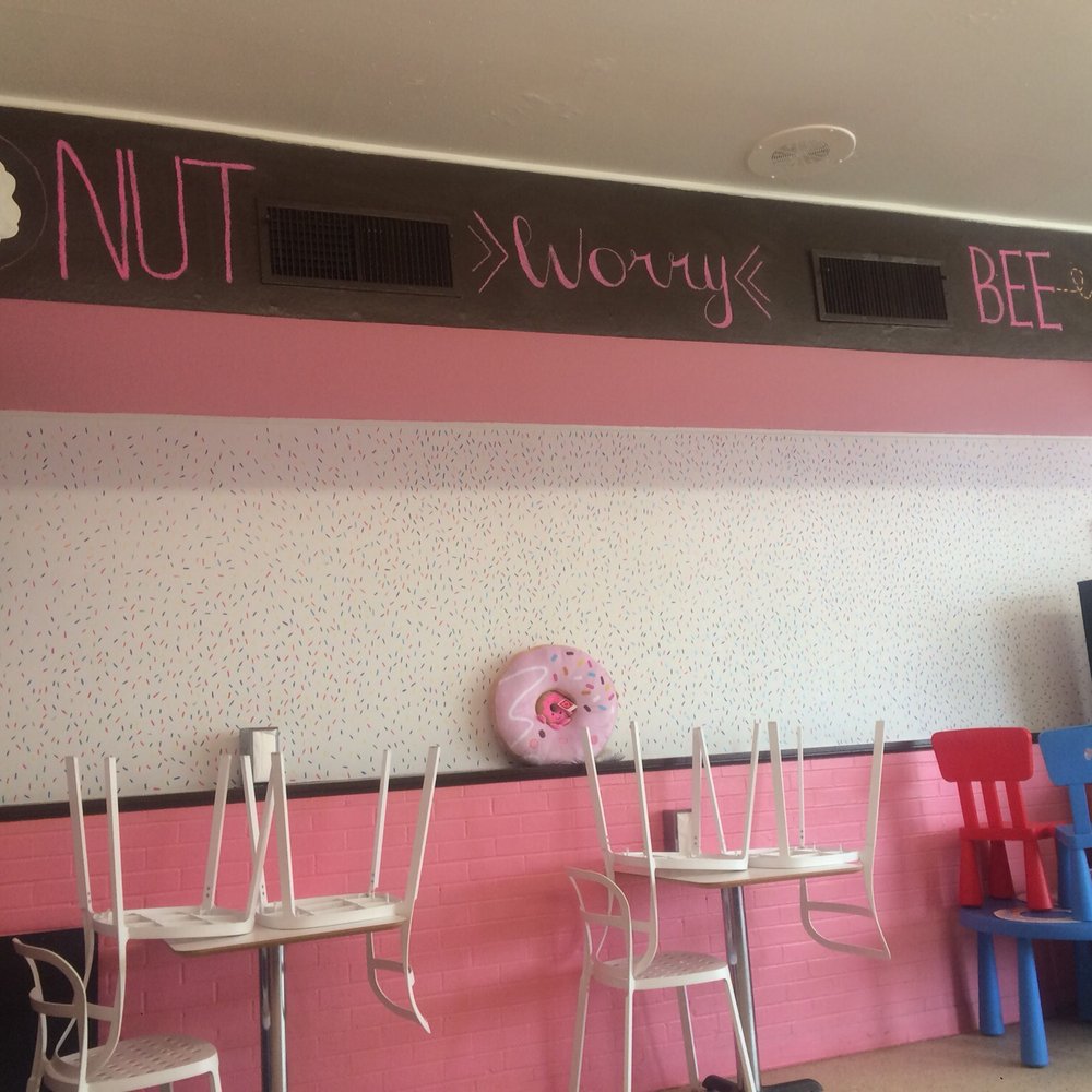 Donut Palace - a row of chairs and a tv - Donuts Near Me - Denison, Texas
