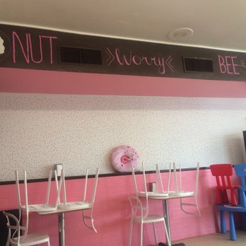 Donut Palace - a row of chairs and a tv - Donuts Near Me - Denison, Texas