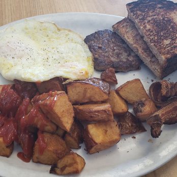 Nana's Kitchen - 2 eggs over medium w/sausage patty and bacon, wheat toast, potatoes and Coffee! - Breakfast & Brunch Near Me - Peyton, Colorado Nana's Kitchen - 2 eggs over medium w/sausage patty and bacon, wheat toast, potatoes and Coffee! - Breakfast & Brunch Near Me - Peyton, Colorado