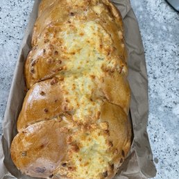 Pan trenza, which is full of cheese on top and inside Pan trenza, which is full of cheese on top and inside