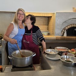 Carefree Romantic Vacations - Taking part in a hands-on cooking experience in Greece. I love helping clients include meaningful local experiences in their travels.