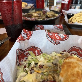 Uncle T's Oyster Bar - The surf and turf poboy and oyster sampler in the background. - Bars Near Me - Scott, Louisiana Uncle T's Oyster Bar - The surf and turf poboy and oyster sampler in the background. - Bars Near Me - Scott, Louisiana