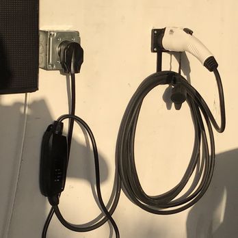 Smart Construction - an electric charger attached to a wall - General Contractors Near Me