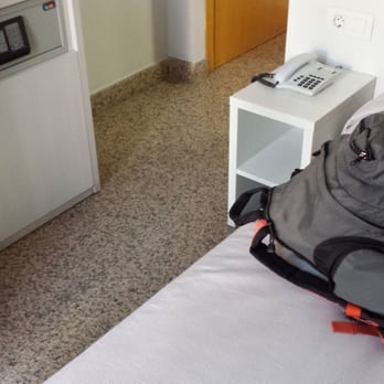 Hotel Nuevo Triunfo - My bag on bed, frig under non-functional room safe - Hotels Near Me - Barcelona, B