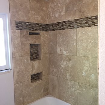 Imperial Construction & Flooring - Custom shower with 18"x18" travertine, triple inset niches, with 6" glass mosaic feature strip. - General Contractors Near Me Imperial Construction & Flooring - Custom shower with 18"x18" travertine, triple inset niches, with 6" glass mosaic feature strip. - General Contractors Near Me