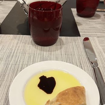 Table 45 - a white plate with bread and olive oil - New American Near Me - Cleveland, Ohio