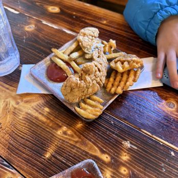 Buffalo Grill - Hochatown - 1/2 of the kid's chicken strips, waffle fries are better than plain. - American Near Me - Broken Bow, Oklahoma