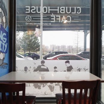 Clubhouse Cafe - a table and chairs in front of a window - Coffee & Tea Near Me - Bronx, New York