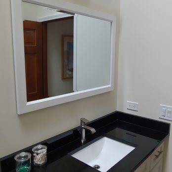 ABA Remodeling - a bathroom with a sink and mirror - Painters Near Me