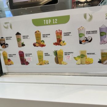 Tbaar - a variety of drinks on display in a store - Juice Bars & Smoothies Near Me - Elmhurst, New York