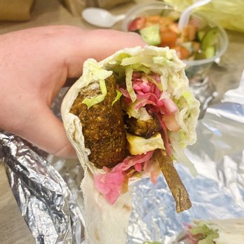 Sunrise Deli - a hand holding a burrito - Delis Near Me - San Francisco, California Sunrise Deli - a hand holding a burrito - Delis Near Me - San Francisco, California