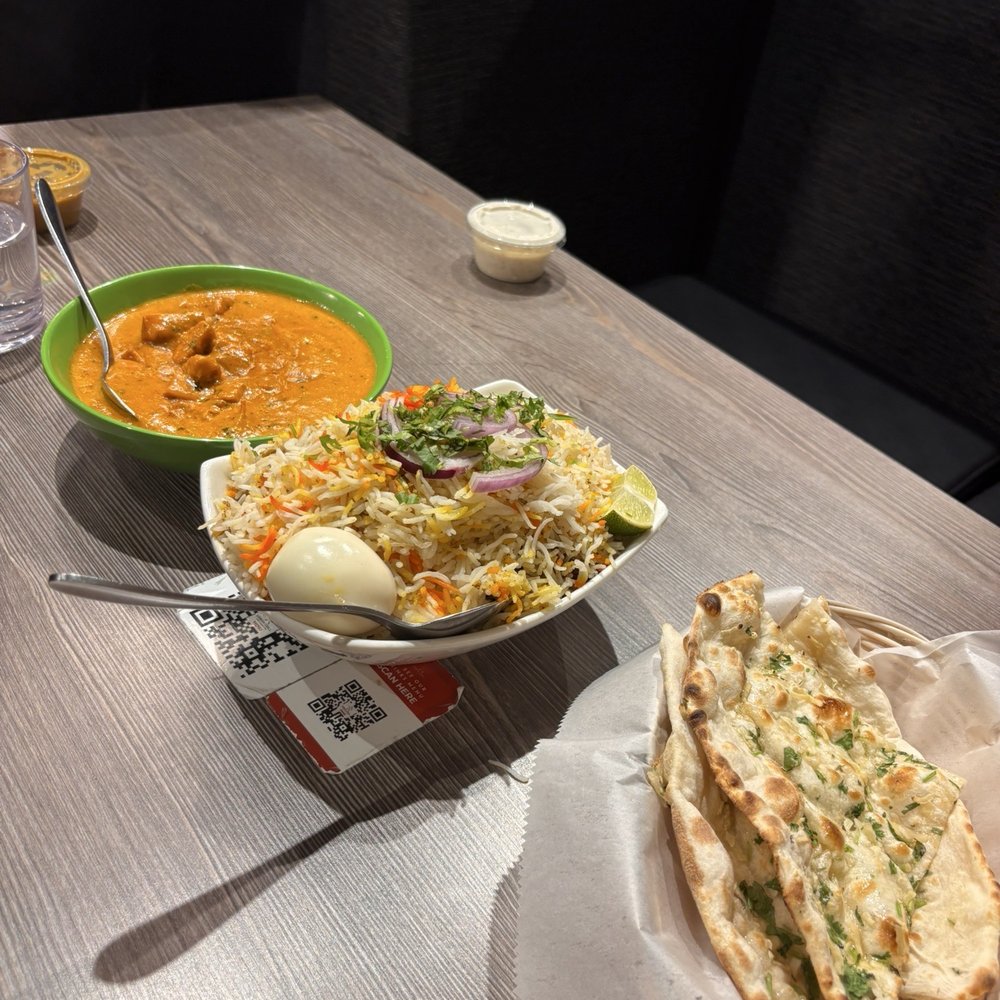 chicken tikka masala, goat biryani, and garlic naan chicken tikka masala, goat biryani, and garlic naan