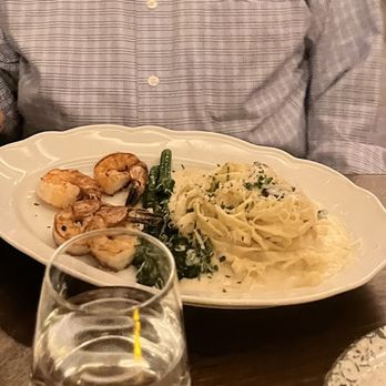 Bella Vista - a man sitting at a table with a plate of food - Italian Near Me - Ridgefield, Washington