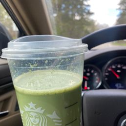 a green drink in a plastic cup