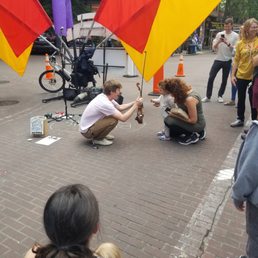 cute interaction between lively street performer and kid cute interaction between lively street performer and kid