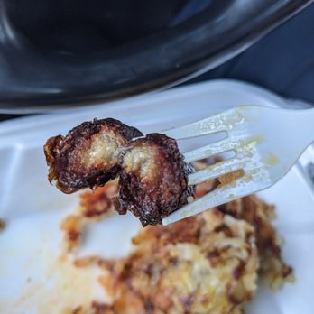 Carson Burgers - a fork holding up a piece of meat - Burgers Near Me - Carson, California