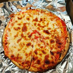 Olcé Pizza Grille - Gluten free cheese pizza cooked on foil to not cross contaminate it with regular flour in the oven.