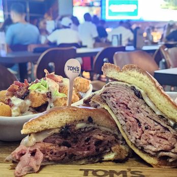Tom’s Watch Bar - Prime Rib Sandwich with loaded tots (loaded is $3 more) - Sports Bars Near Me - Orlando, Florida