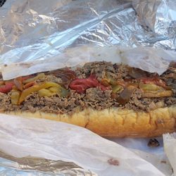 Gooey Looies - Cheesesteak hero with white American cheese, sweet peppers, fried onions and mayo.