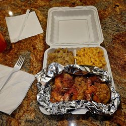 Caribbean Soul Food Delight - Colossal stuffed shrimp with sides of cabbage and Mac and cheese.