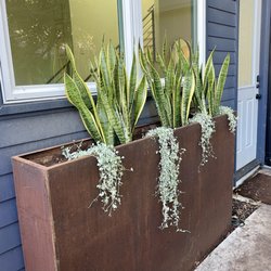 Austin Yard Barber - Yonder steel planter what were tall n' slim.