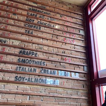 Coffee Bear Silverton - a brick wall with signs on it - Coffee & Tea Near Me - Silverton, Colorado